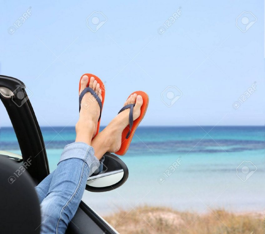 27508143-closeup-of-woman-s-feet-by-convertible-car-window.jpg