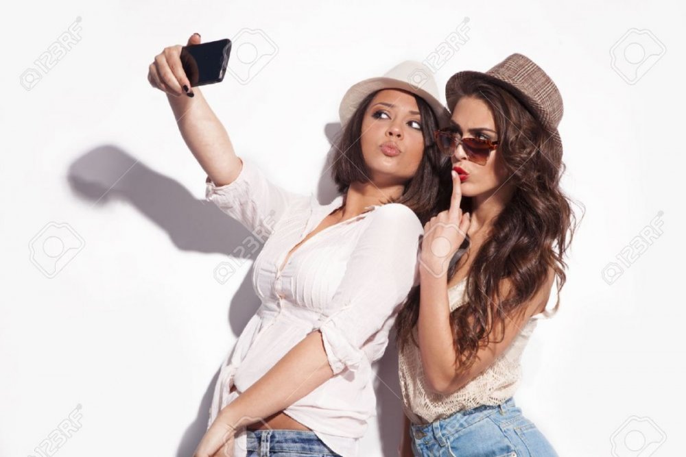28343900-two-young-women-taking-selfie-with-mobile-phone.jpg
